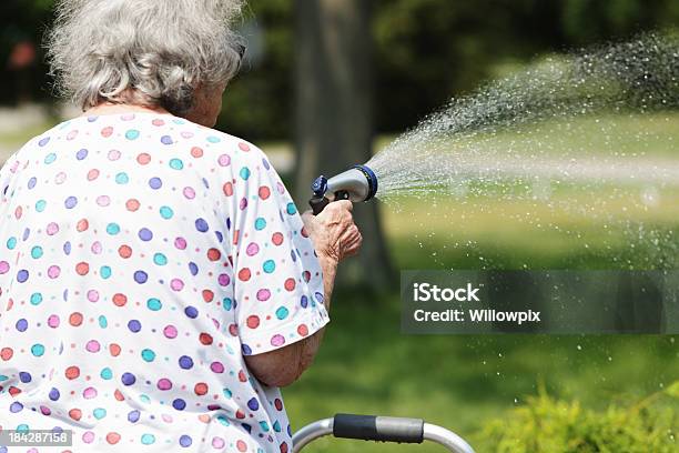 Senior Frau Sprühen Wasser Spritzen Mit Garten Stockfoto und mehr Bilder von 80-89 Jahre - 80-89 Jahre, Aktiver Lebensstil, Aktiver Senior