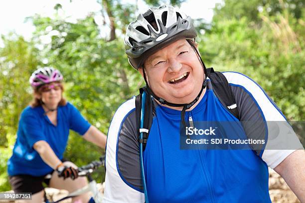 Happy Biker With Partner Behind Him Stock Photo - Download Image Now - 30-39 Years, Activity, Adult
