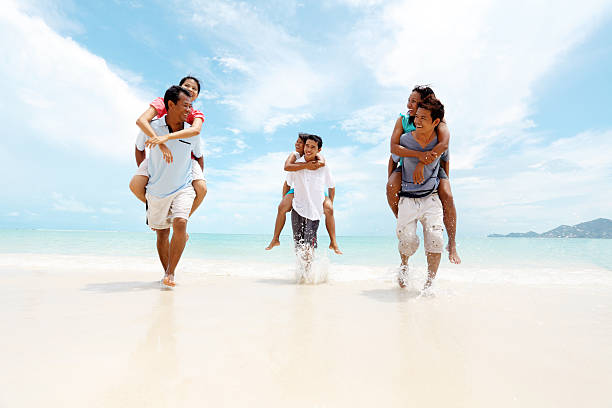 istock Group of Asian couples on a piggyback ride. 184287450