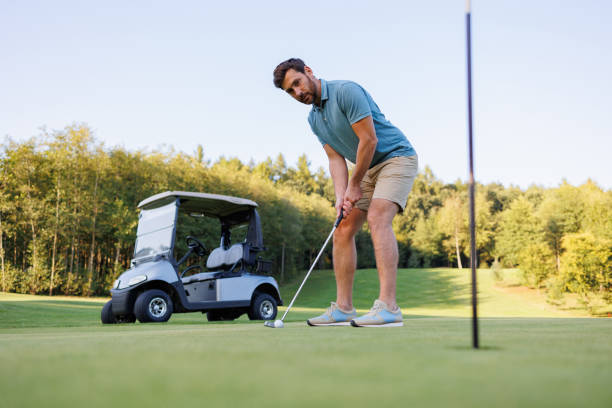 istock Golfing Finish: Player, Cart, and Hole Close-up 1842875405