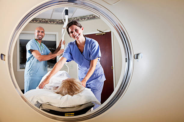 istock Healthcare workers preparing patient for CT scan 184287742