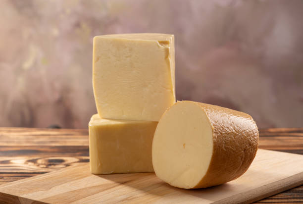 istock Cheeses, beautiful pieces of cheese placed on rustic wood, selective focus. 1842879456
