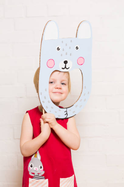 istock Little girls holding rabbit mask on white background 1842880183