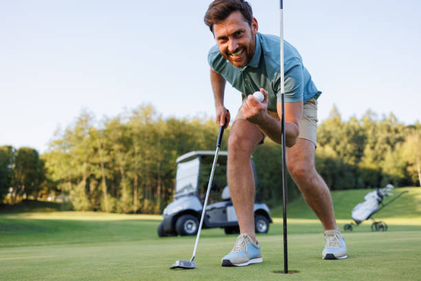 istock Final Triumph: Golfer Collects Winning Ball 1842880197