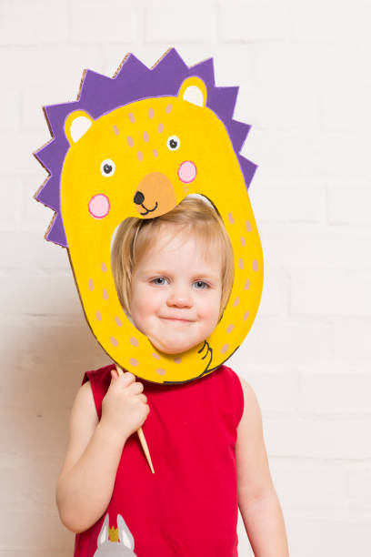 istock Little girls holding hedgehog mask on white background 1842880201
