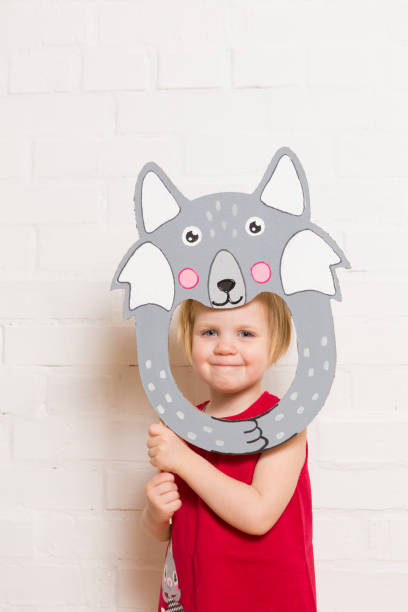 istock Little girls holding wolf mask on white background 1842880212