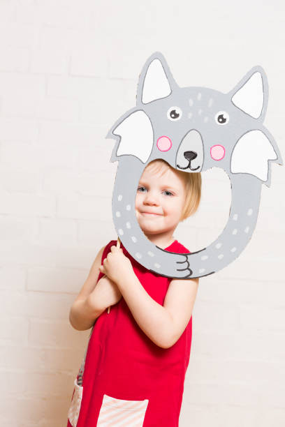 istock Little girls holding wolf mask on white background 1842880218