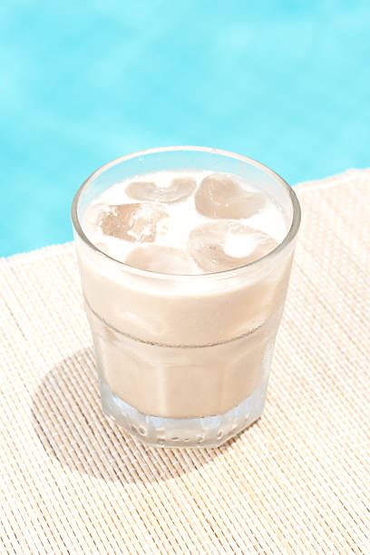 Classic white russian cocktail near waterpool on the mat stock photo