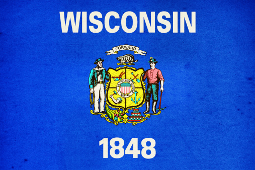 US state of Wisconsin paper flag close up with light effect and vignette. Visible paper texture for super realistic effect. Selective focus. Canon 5D Mark II and Sigma lens.SEE MORE US STATE FLAGS BELOW: