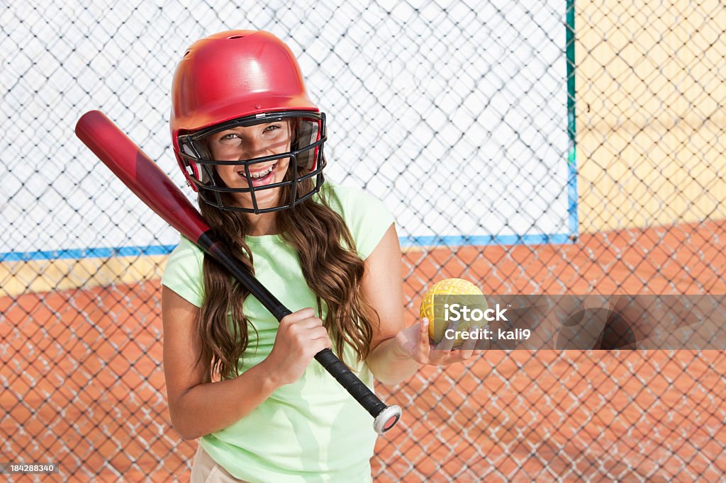 Girl in batting cage "Girl in batting cage, hitting practice balls.  11 years." Girls Stock Photo