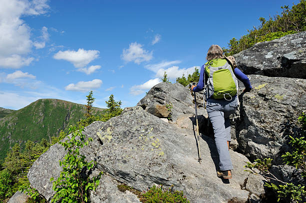 Beautiful scene of a woman hiking in mountains.