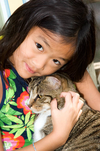 istock Girl cuddling with her cat 184288842