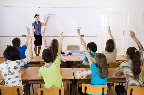 istock Pupils in classroom responding to the teacher's question. 184289041