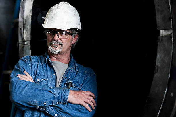 istock Factory worker wearing hard hat and safety glasses 184289139