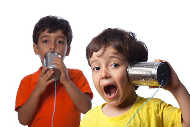 istock Two Little Boys Talking And Communicating On Tin Can Phone 184289314