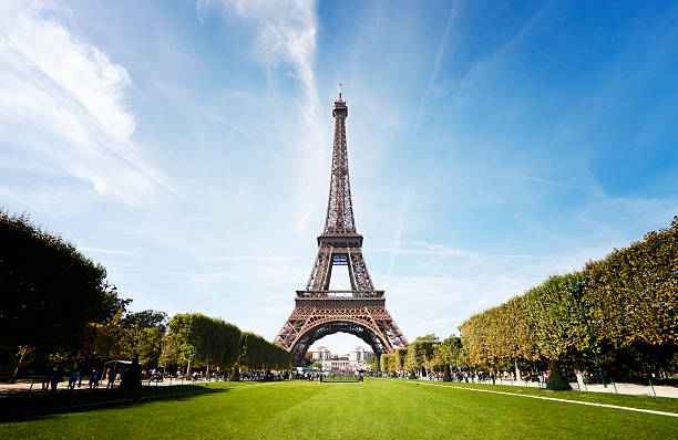 Eiffel Tower, Paris Wide angle shot of the Eiffel Tower taken from the Champ de Mars. eiffel tower stock pictures, royalty-free photos & images