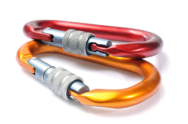 Close up macro image of an orange and red carabiner.