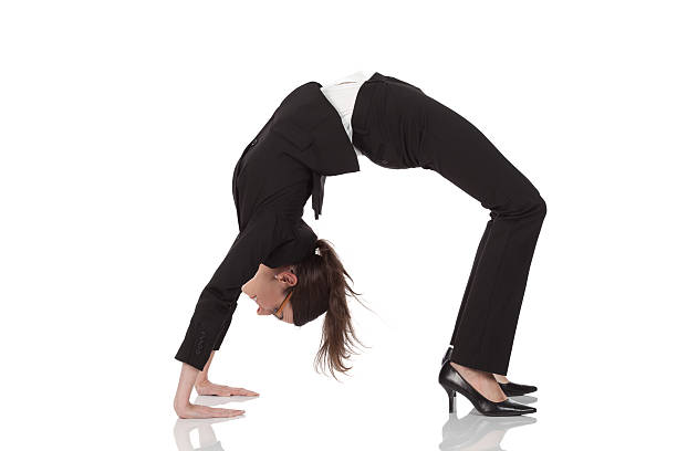 Businesswoman practicing yoga Businesswoman practicing yogahttp://www.twodozendesign.info/i/1.png bending over backwards stock pictures, royalty-free photos & images