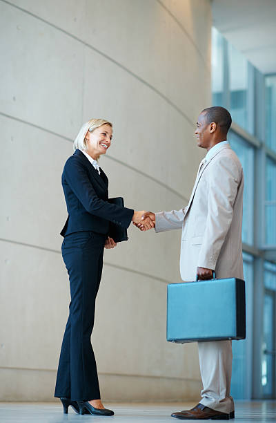 istock Happy executives shaking hands 184290869