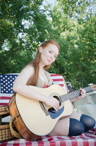 istock Beautiful woman playing guitar 184290974