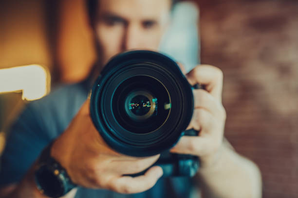 istock Young man photographer making selfie at mirror, focus on camera 1842909983