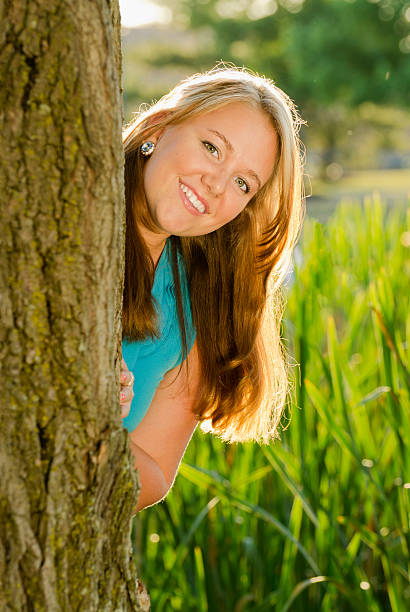 istock Pretty Brunette Teen Backlit Behind a Tree 184291768