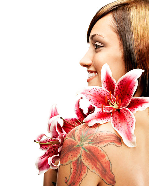 Profile of Beautiful Woman with Stargazer Lilies and Matching Tattoo stock photo
