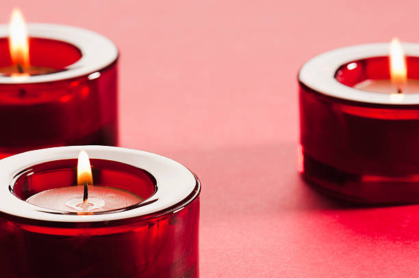 istock Red glass candle holders with lit tea light candles 184292111