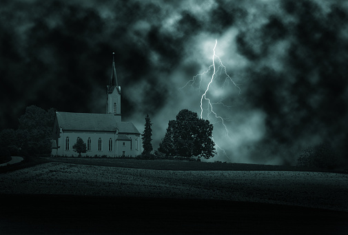 Thunder storm and lightning above church.