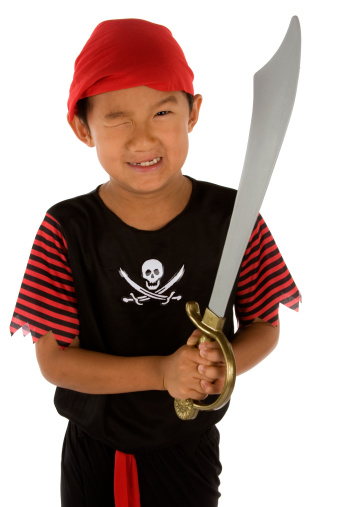 Little boy dressed as pirate with sword
