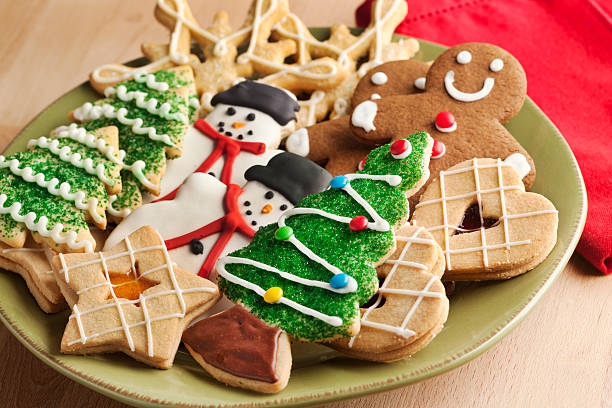 Display of Christmas Decorated Cookie Plate Hz Subject: A plate filled with Christmas sweet cookies decorated with frosting and icing. Christmas Tree Cookie stock pictures, royalty-free photos & images