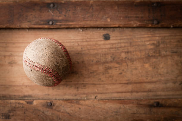 Old, Worn Baseball on Antique Wooden Trunk