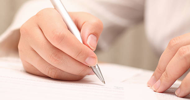 istock Woman about to sign a document with a silver pen. 184293750