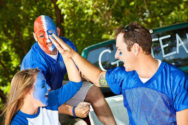 istock Fans on Truck Tailgate Giving High Fives 184293818