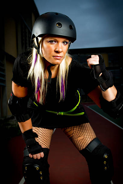 Attractive young Roller Derby Girl in an aggressive pose.