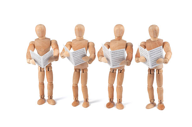 istock wooden mannequin singing with sheet music 184294116