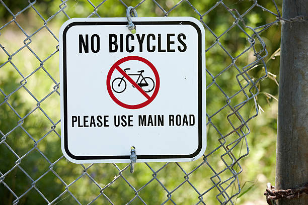 istock No bicycles allowed sign on chainlink fence 184294429