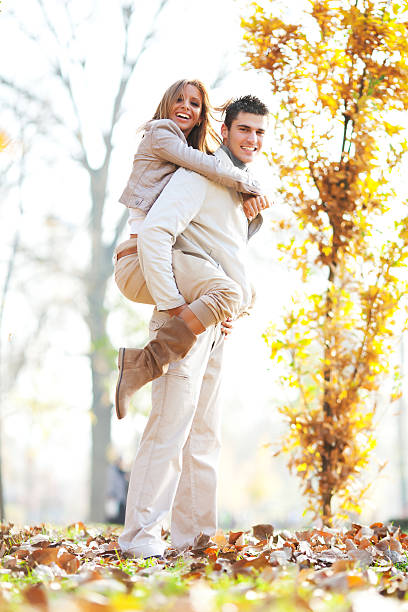 istock Young man giving his girlfriend a piggyback ride. 184294763