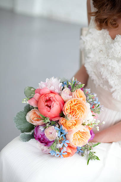 Bride holding rose bouquet stock photo