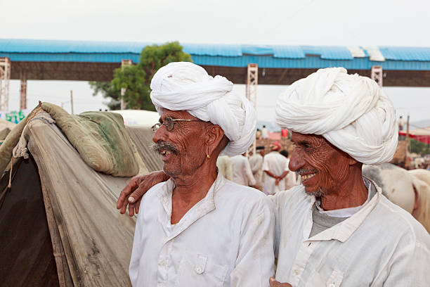 Friends laughing tribal men in Rajasthan India stock photo