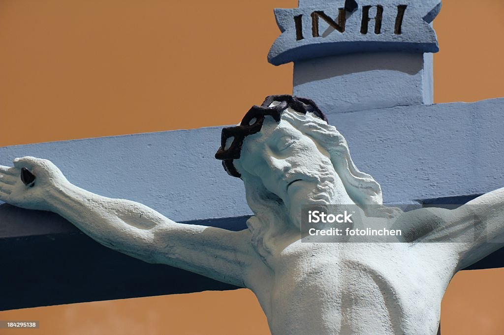 Jesus Christ A statue of Jesus Christ on the cross. Blue Stock Photo