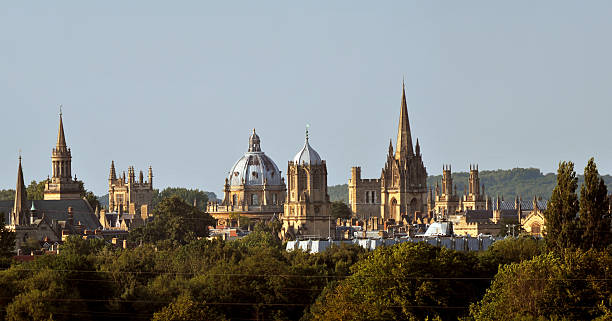 Oxford Dreaming Spires The skyline and golden spires of Oxford University at duskUK oxford university photos stock pictures, royalty-free photos & images