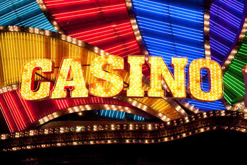 Bright casino sign lit with bulbs and neon lights.