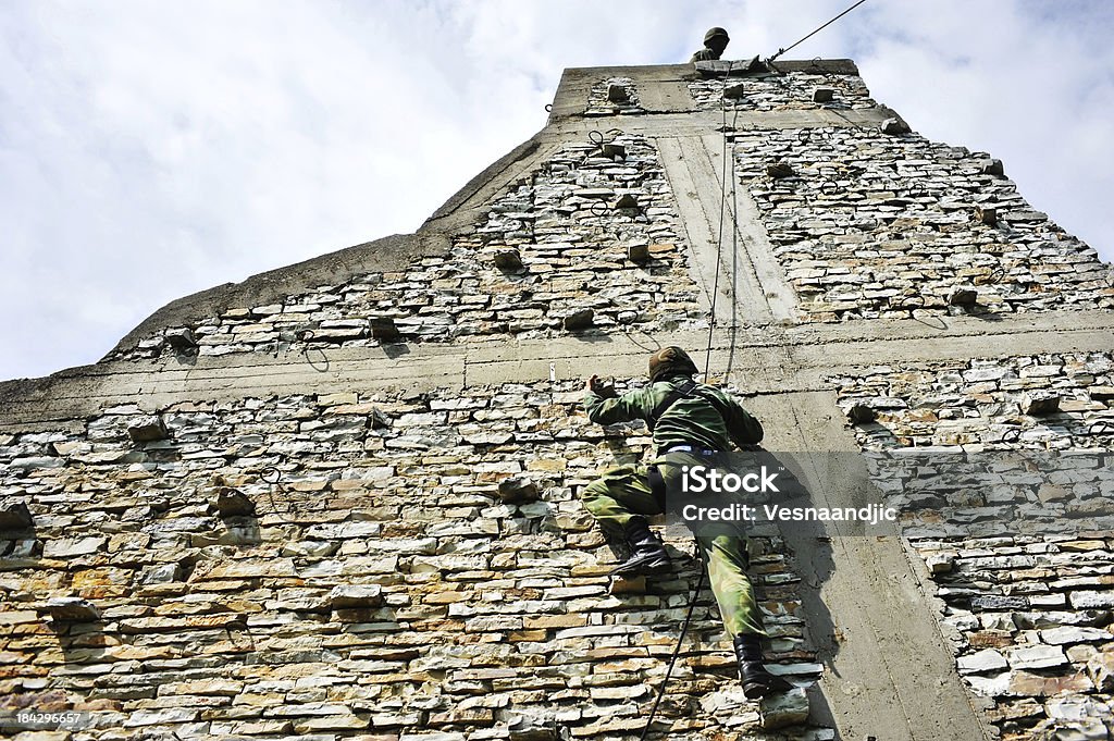 SWAT soldier climbs a wall as part of training for admission to special units Military Stock Photo