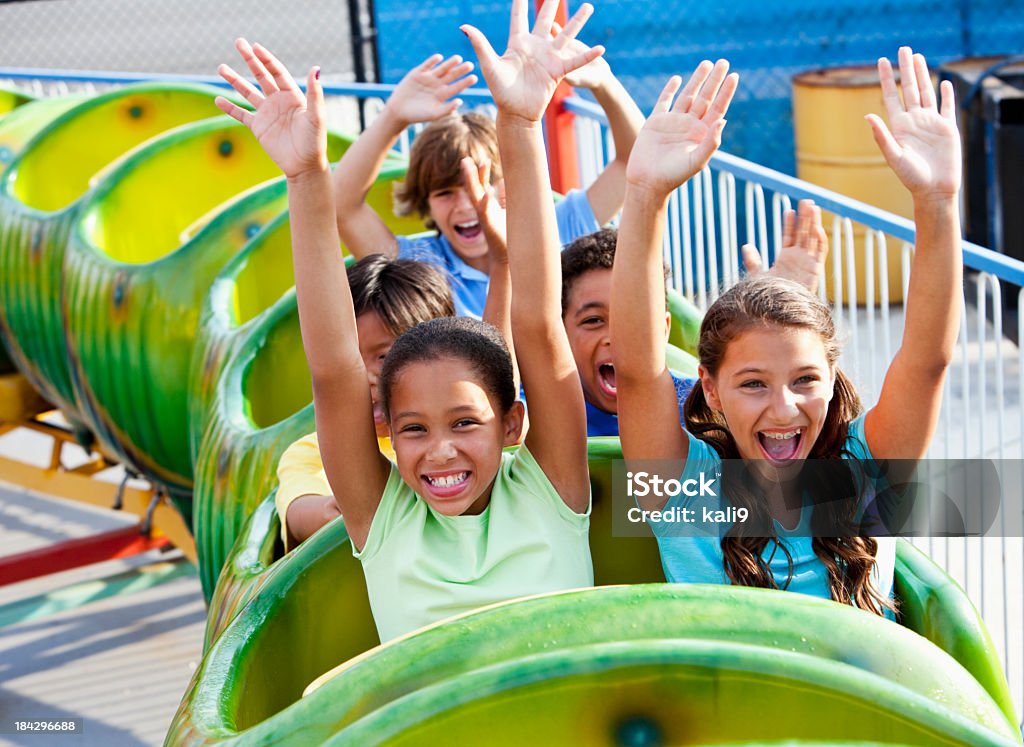 Дети, езда на зеленый roller coaster - Стоковые фото Американские горки роялти-фри