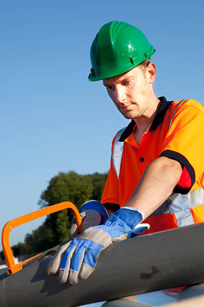 istock Manual worker busy with road construction. Blue sky on background. 184296711