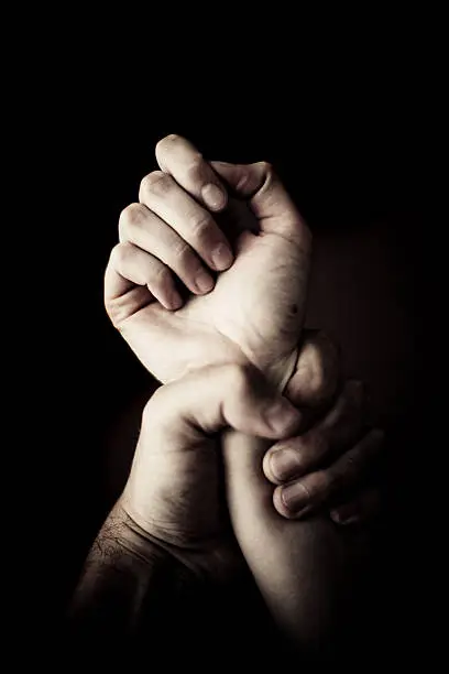 Man holding female hand.