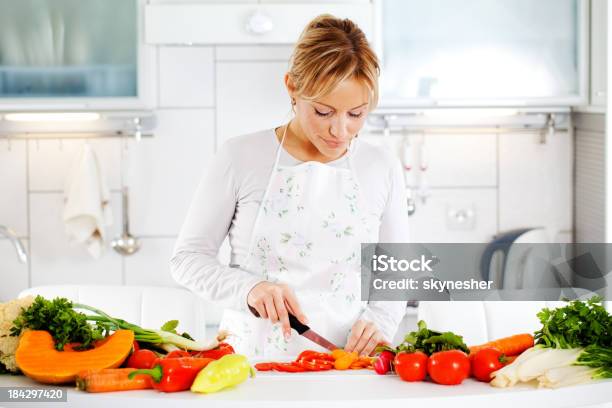 Young Woman Cutting Carrots Stock Photo - Download Image Now - Adult, Adults Only, Apron