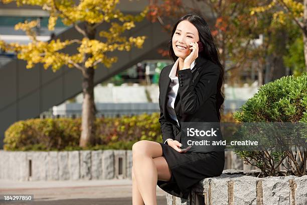 Asian Female In Suit Uses Cell Phone Stock Photo - Download Image Now - 20-24 Years, 20-29 Years, Adult