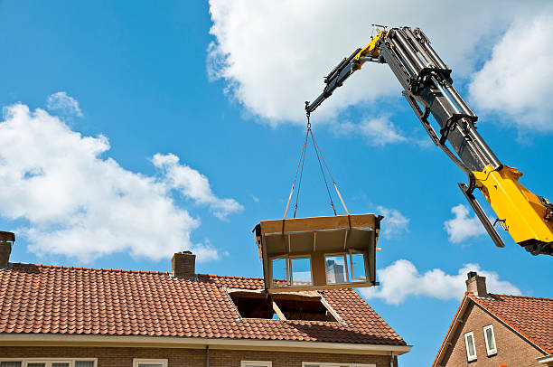 Dormer Construction A prefab dormer is raised with a crane to a hole in a roof Similar images: dormer stock pictures, royalty-free photos & images